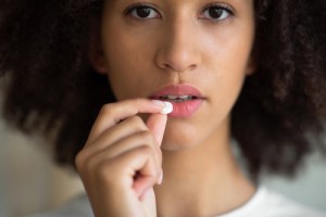 woman holding oral sedation pill